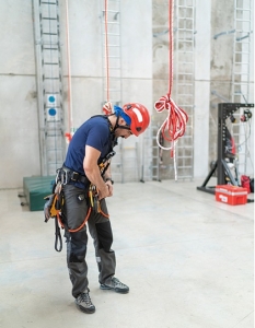 Preparing Climber person putting on rope access equipment